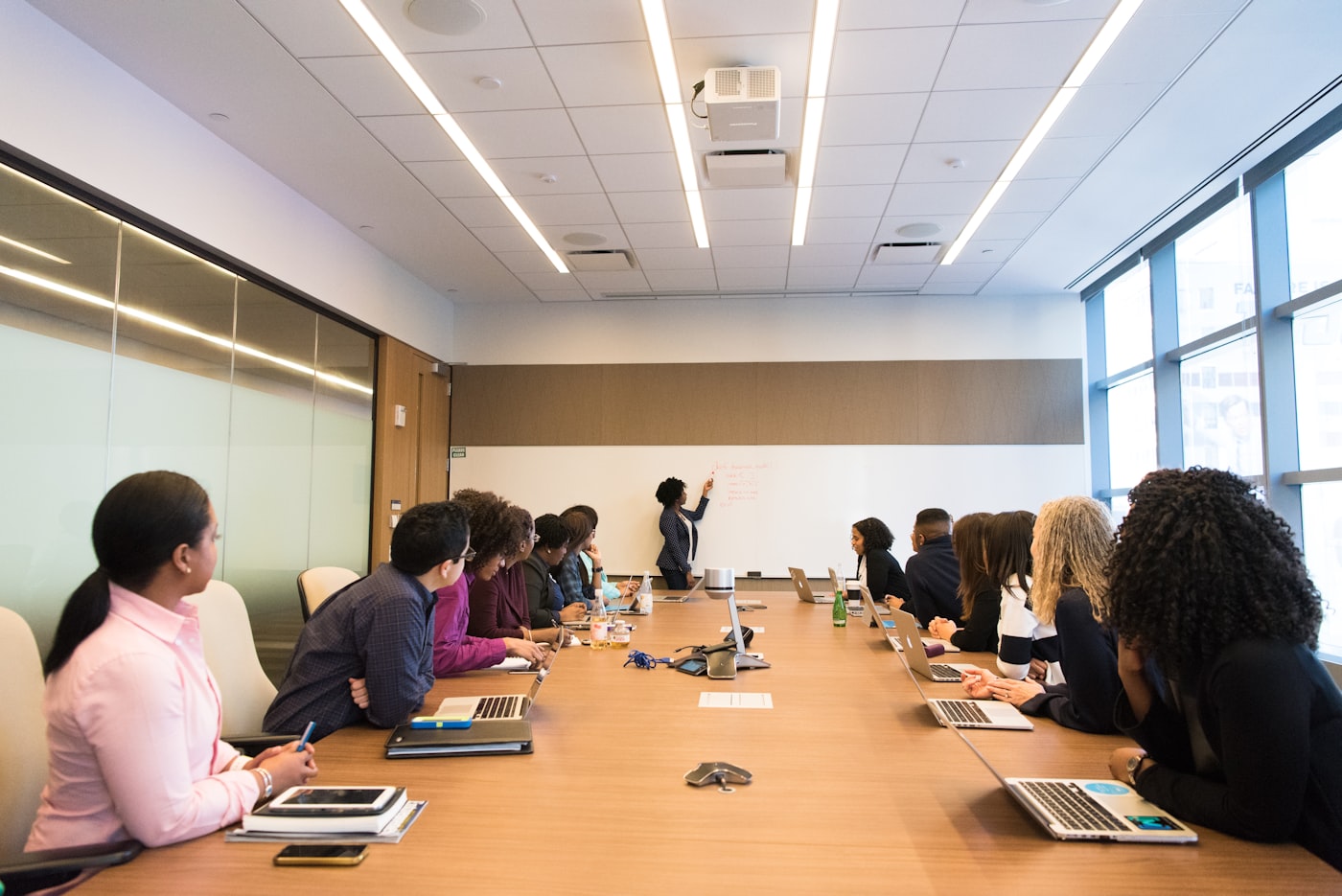 Executives reviewing material together at a boardroom table