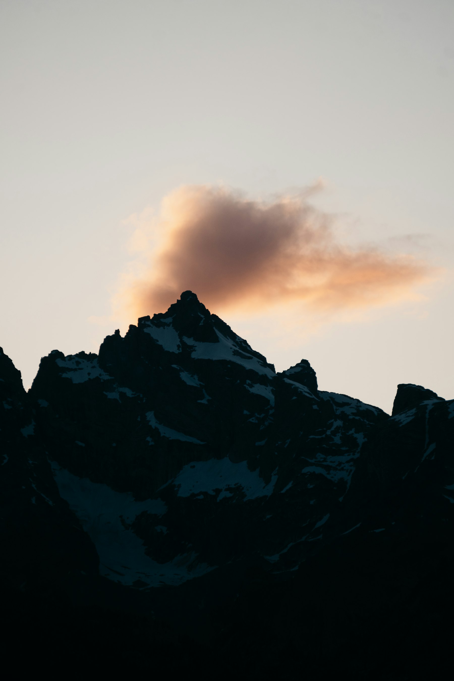Mountain range above the clouds at dusk